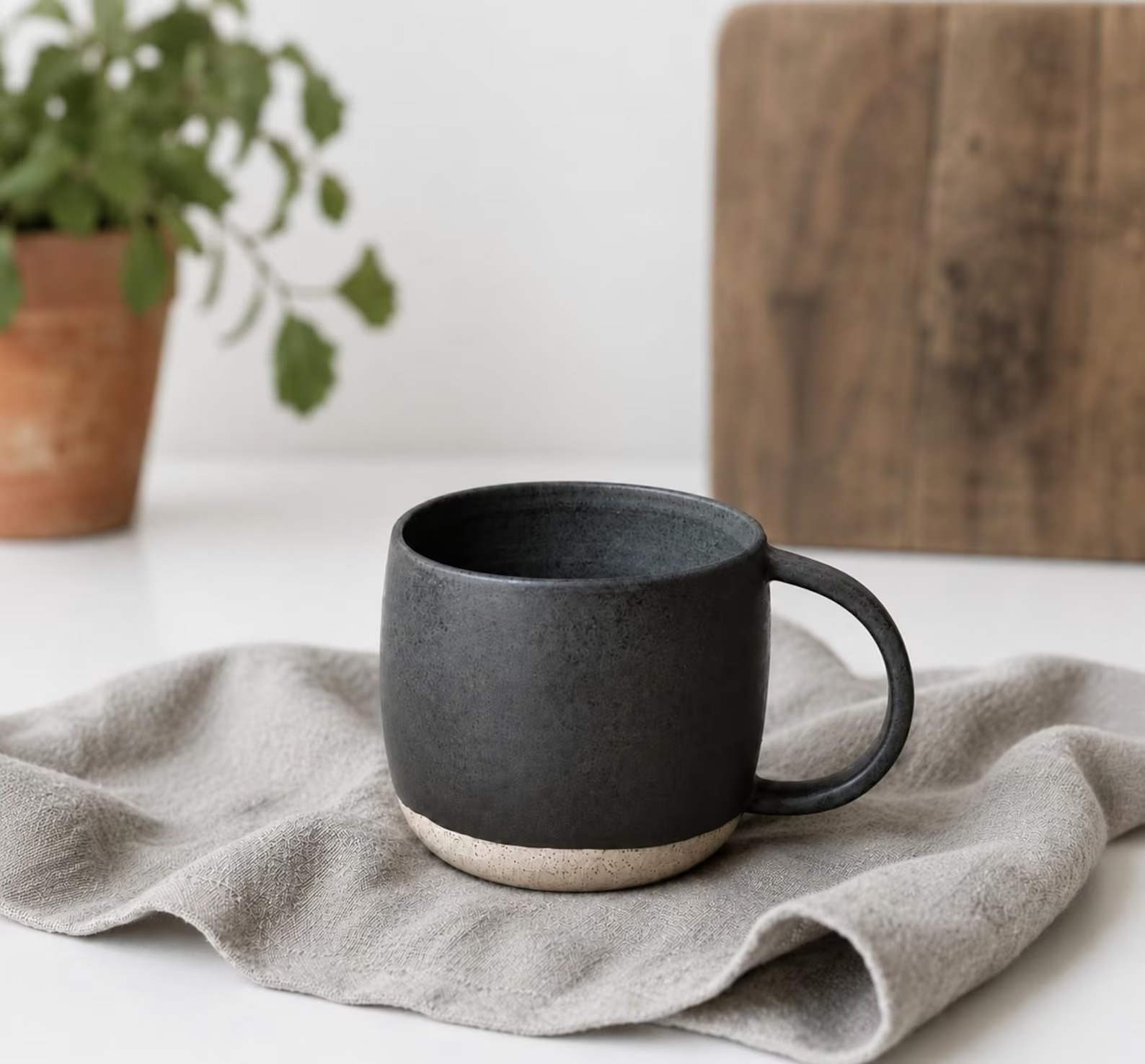 Larger ceramic mug with a handle in a dark matte glaze
